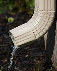 Close up of water running out of downspout